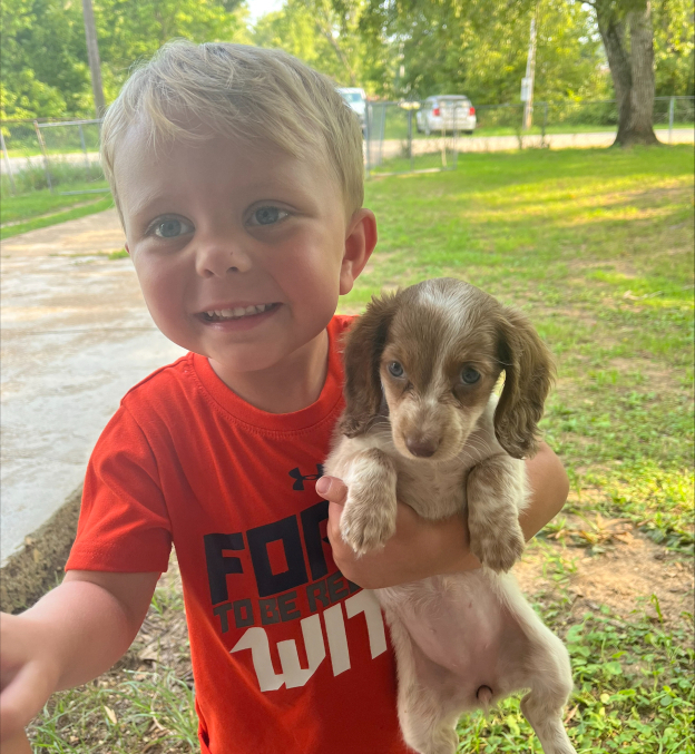 Kasen Conn holding a puppy