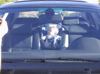 child hand pressed up against car window