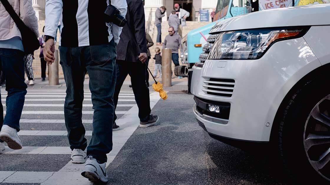 Pedestrians walking in front of a car