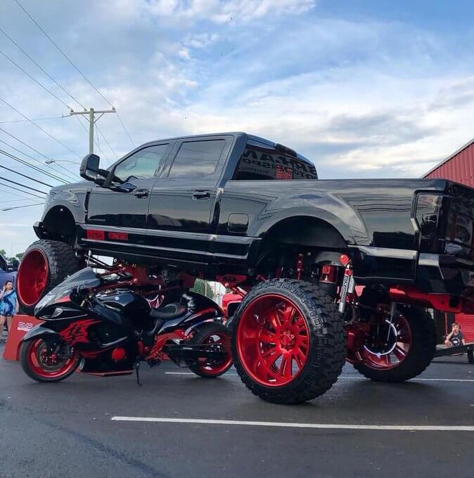 Motorcycle under a truck
