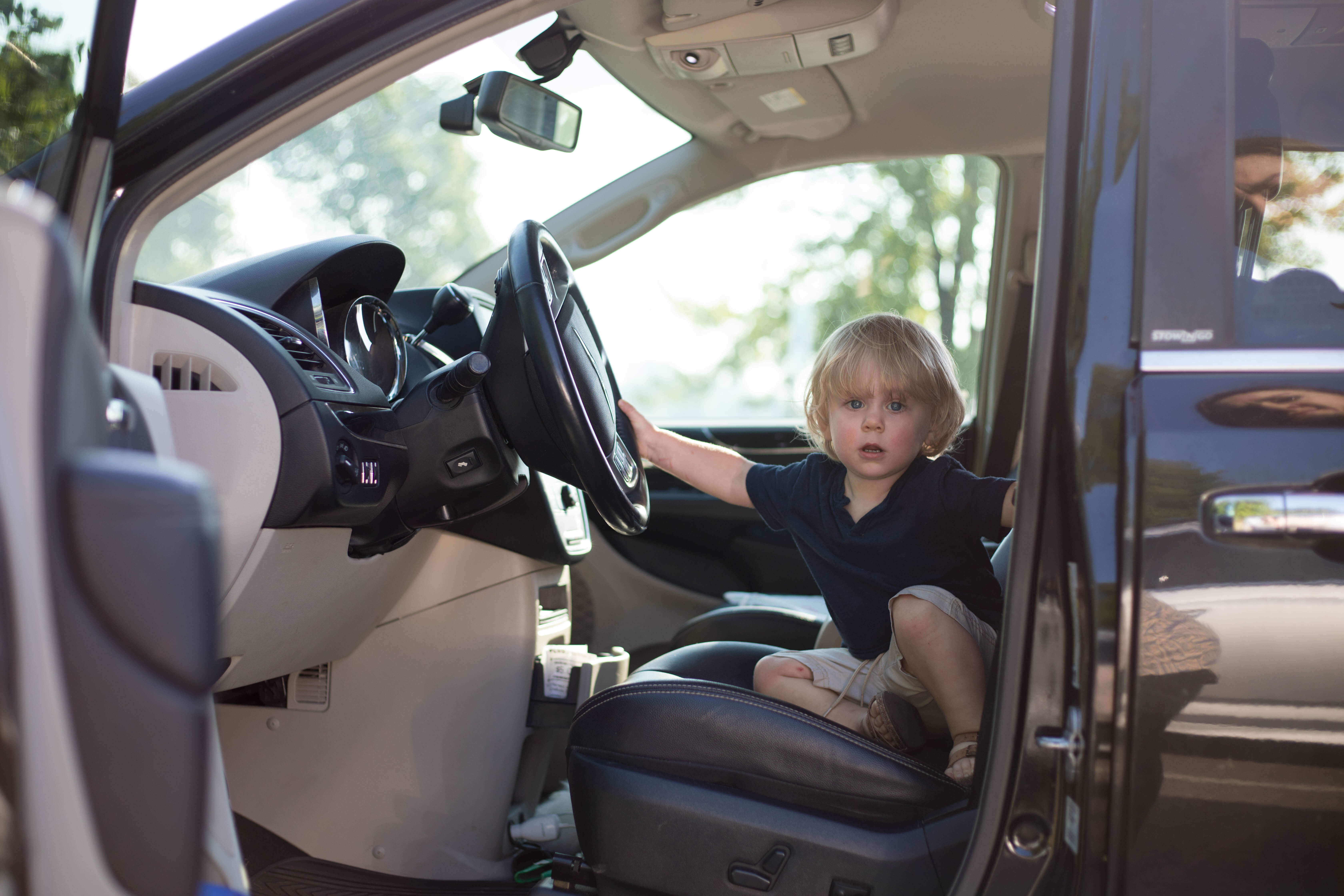 child in front seat of car