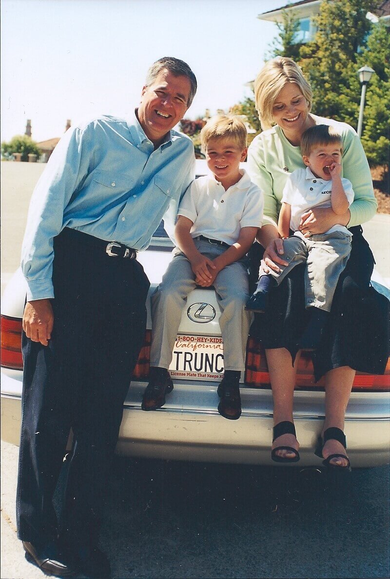 Fennell family candid sitting on car