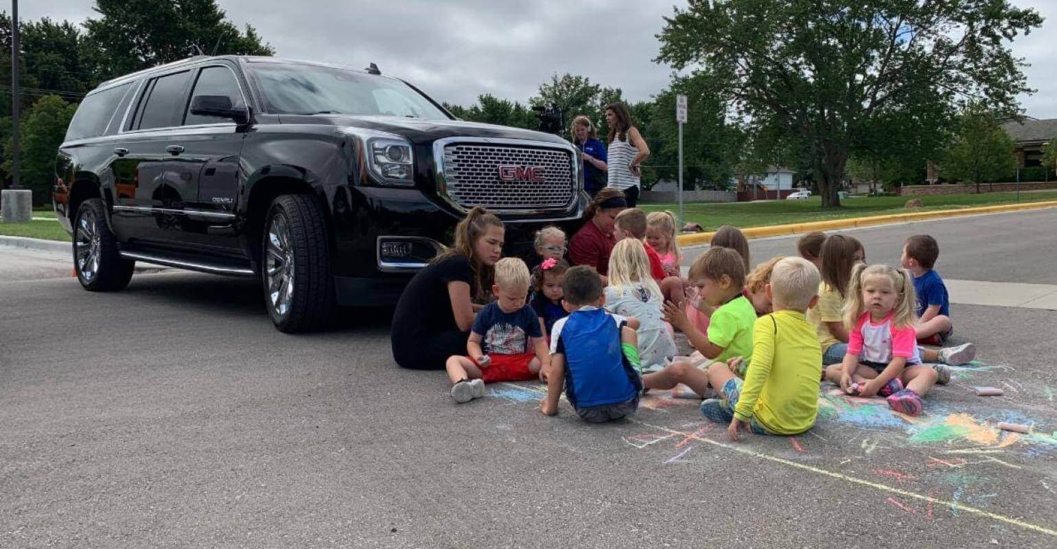 Kids in front of a car