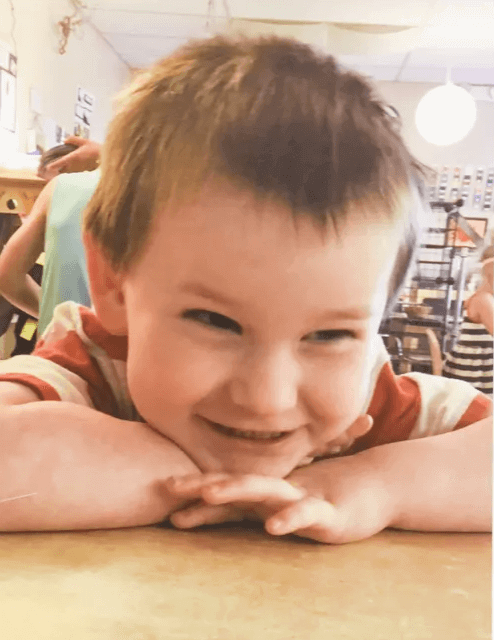 A framed picture of three-year-old Oliver sits on a mantle in the Dills' living room. The picture was taken at the University of Southern Indiana's Children’s Learning Center and given to the family after his death in 2019.