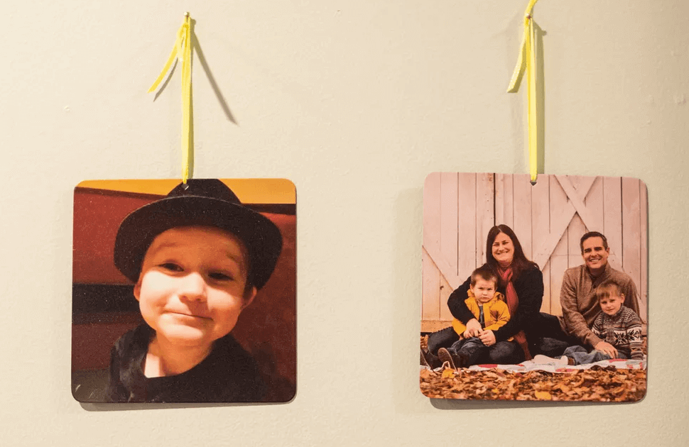 Two pictures, one of Oliver Dill and another of him with his family, are displayed on a wall in the Dill family's home in Evansville. Ollie – who would have turned 5 years old on June 2 – is one of 16 Indiana children under the age of 14 who died in hot cars between 1990 and 2020.